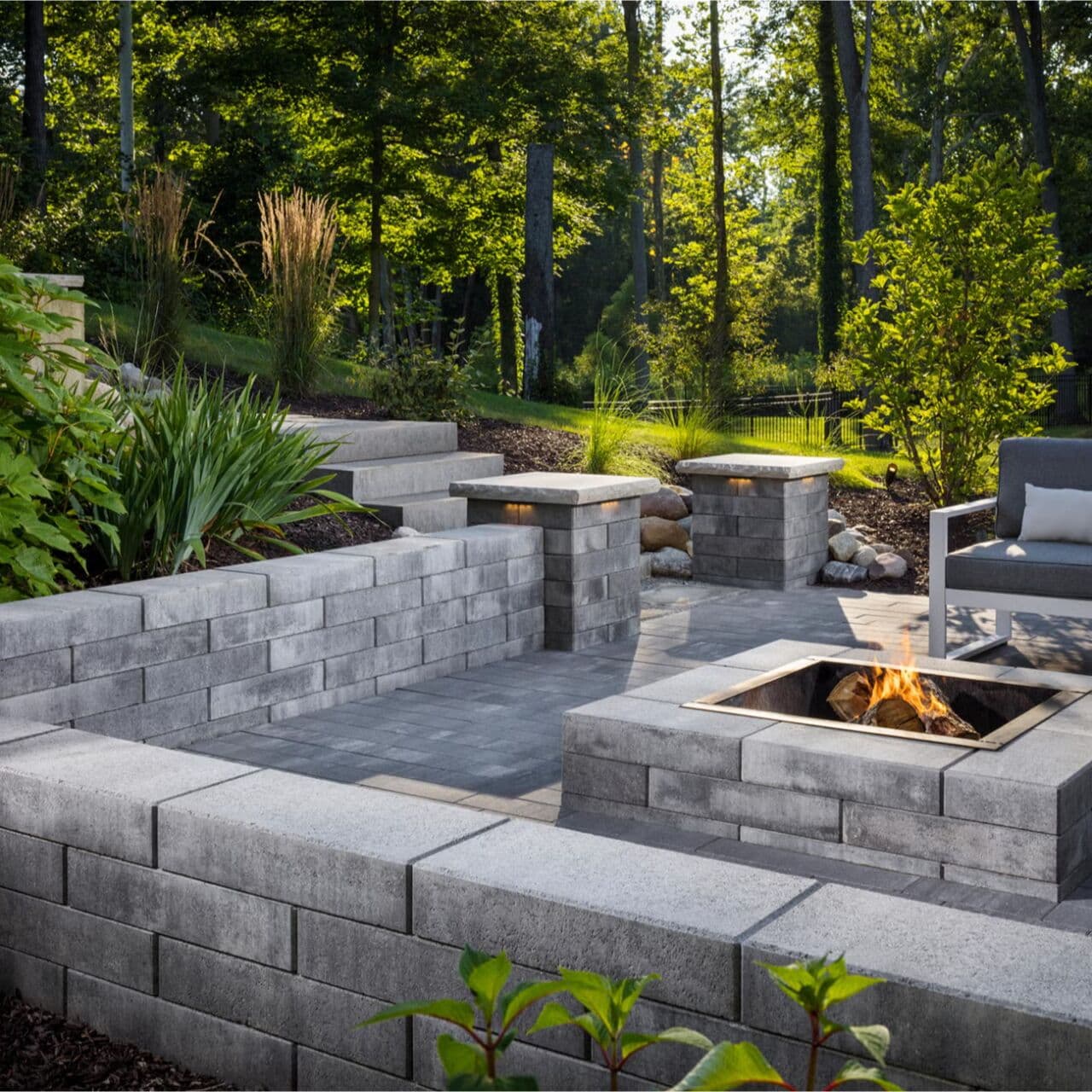 Melville low linear garden walls with planted beds around a paver patio — Daedalus Contracting, Lower Mainland BC