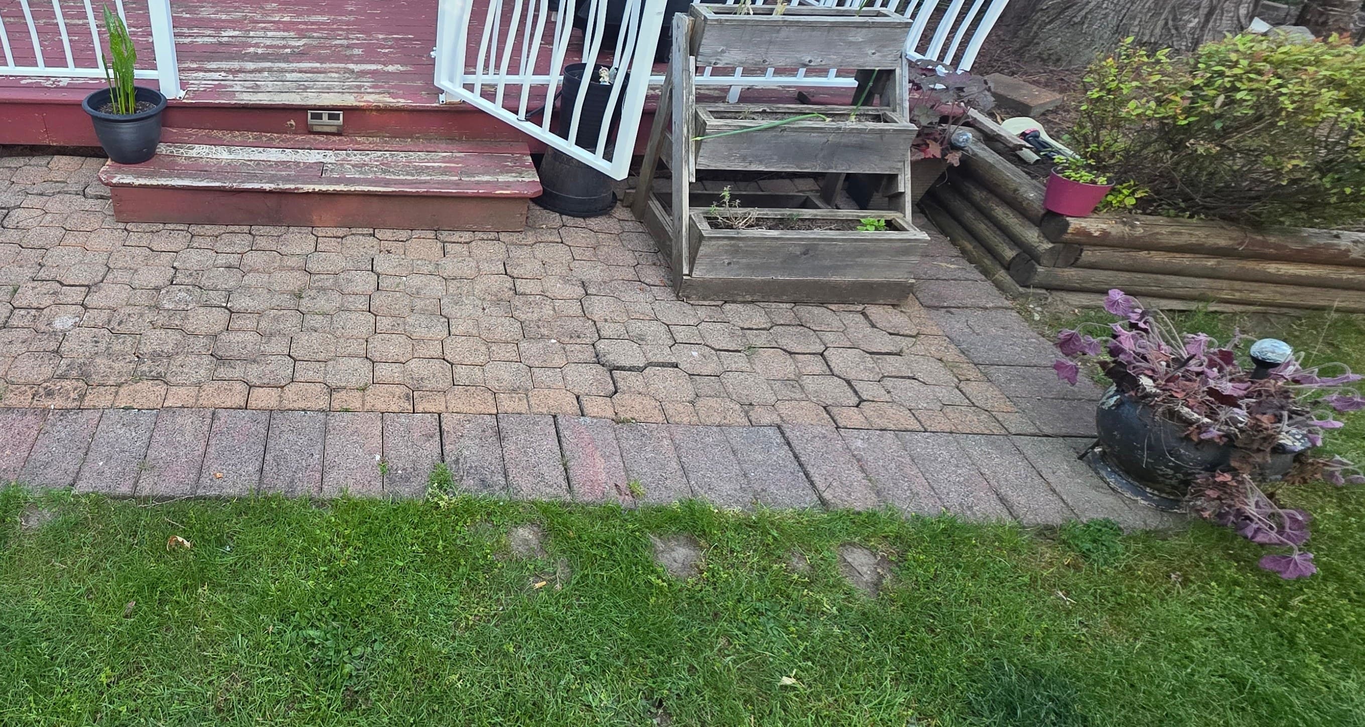 Aged interlocking paver patio with shifted rows, opened joints and a sinking edge — Daedalus Contracting, Lower Mainland BC